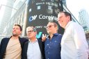CoreWeave executives pose in front of the Nasdaq building on the day of the company's IPO.