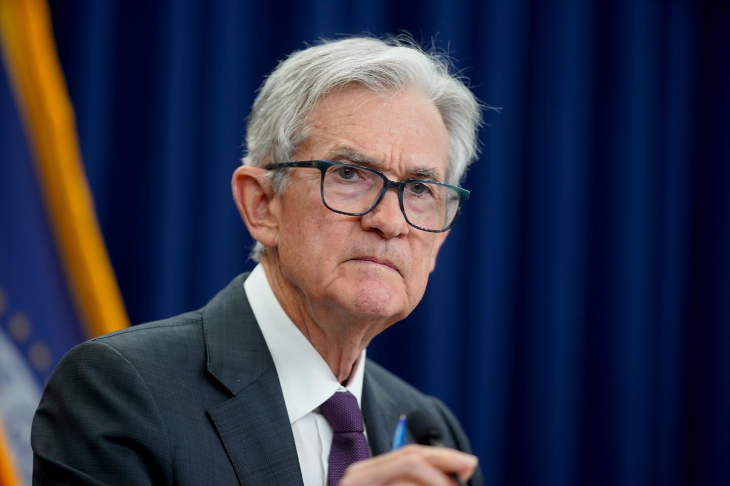 Jerome Powell, wearing a suit, looks ahead with his brow furrowed.