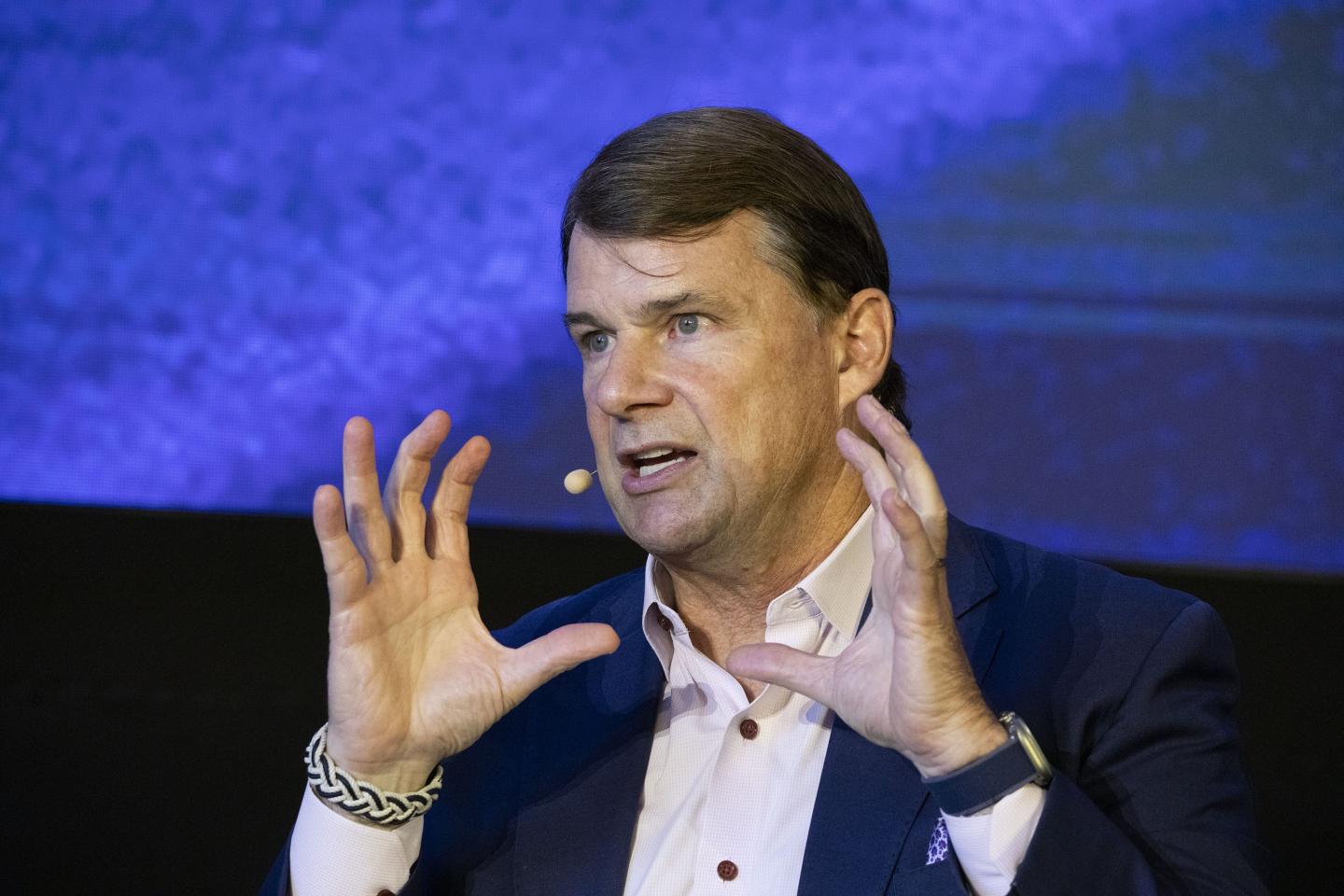 Jim Farley with his hands raised
