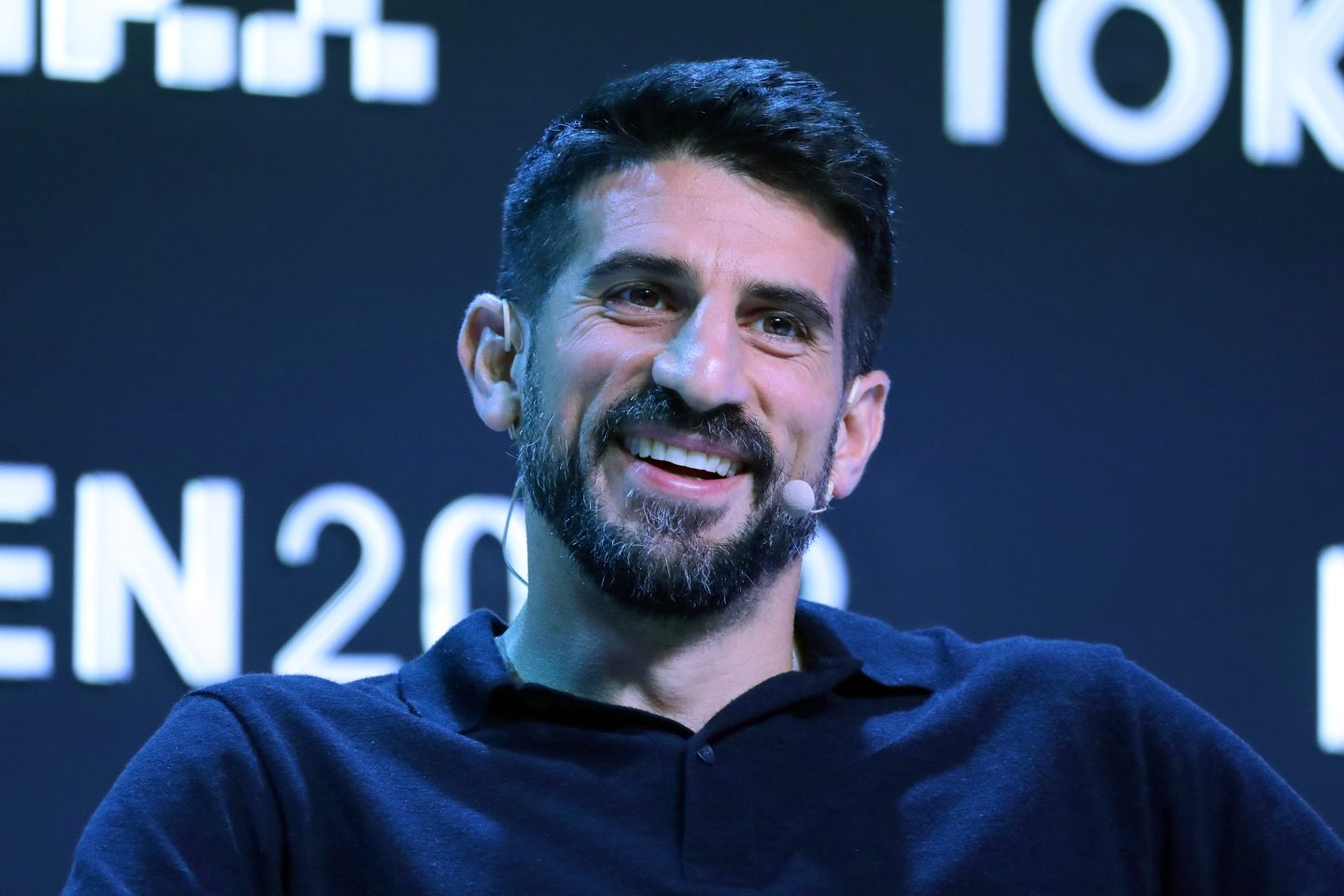 Man smiles in front of camera