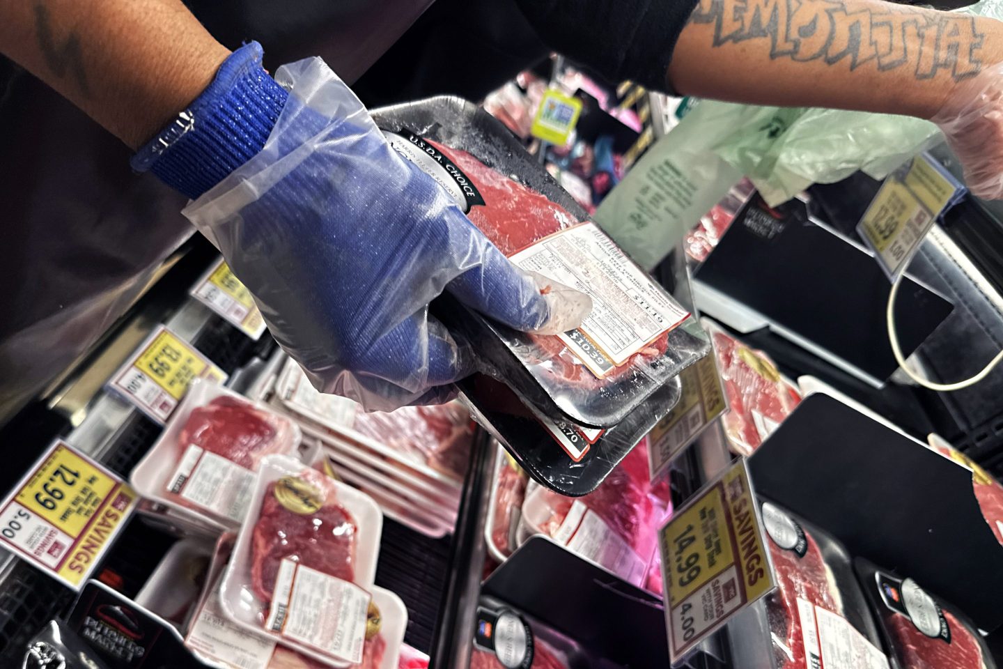 A worker stocks angus beef top sirloin filets in the meat section of a grocery store in Washington, D.C., on Saturday, October 25, 2025.