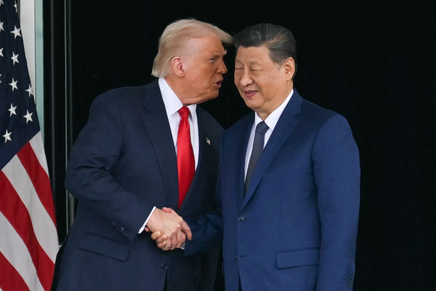 U.S. President Donald Trump (L) and China's President Xi Jinping shake hands as they leave after their talks at the Gimhae Air Base, located next to the Gimhae International Airport in Busan on October 30, 2025.