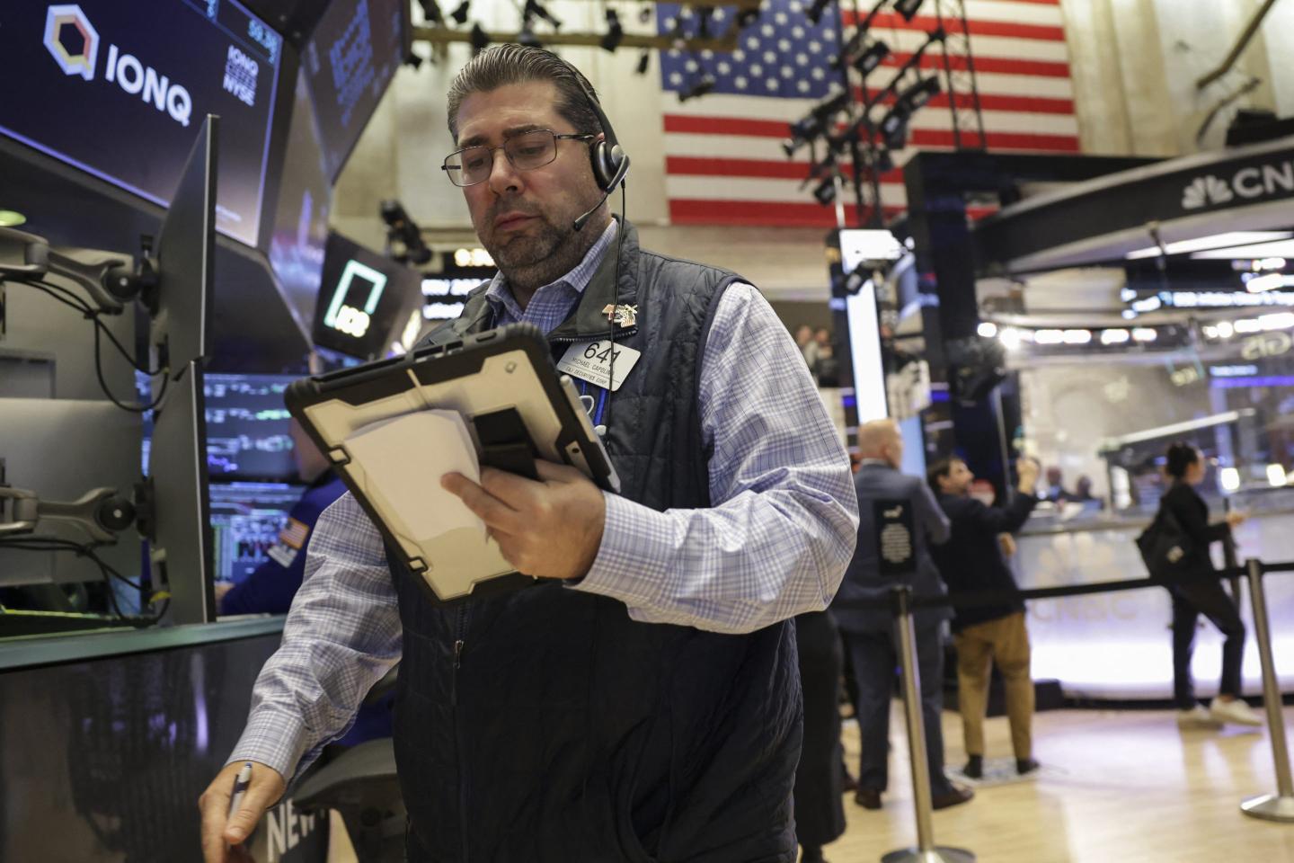 Traders work on the floor of the New York Stock Exchange (NYSE) in New York on October 30, 2025.
