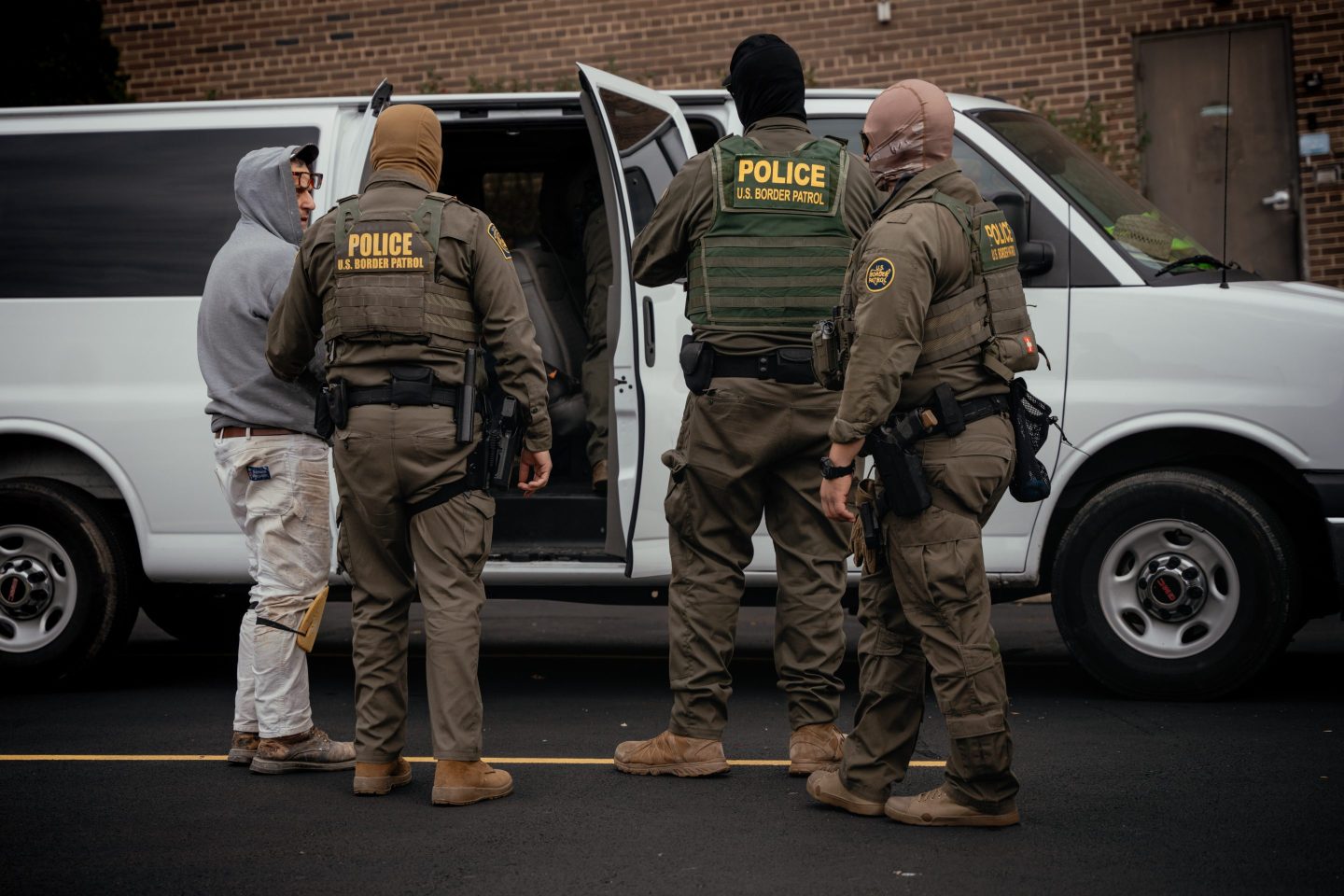 People detained earlier in the day are taken to a parking lot on the far north side of Chicago on Oct. 31.