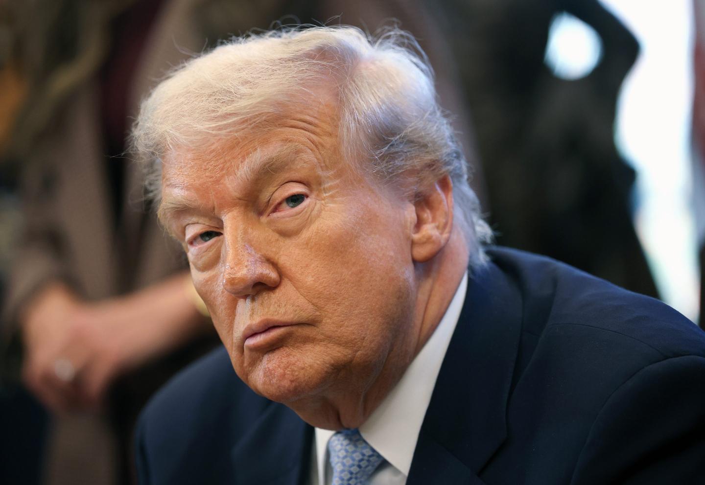 U.S. President Donald Trump listening to remarks.