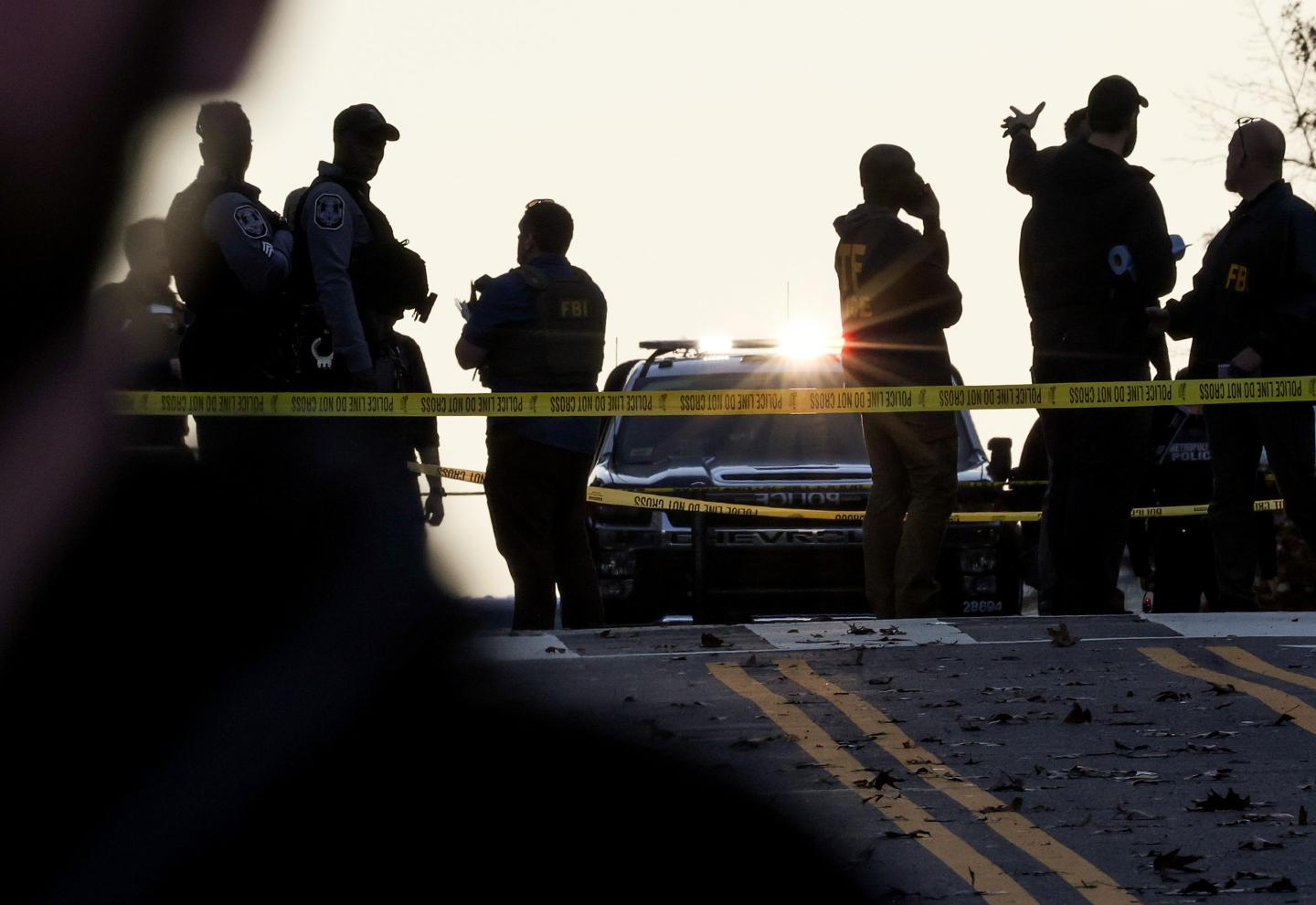 The silhouettes of National Guard members against the sunlight