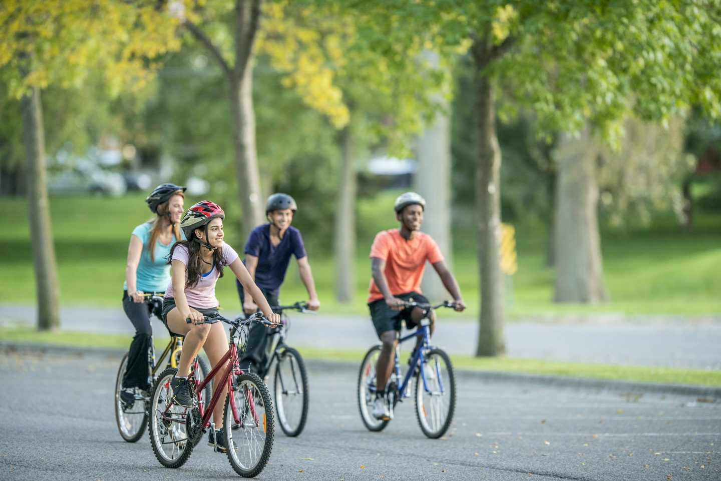 Young adults out riding bikes.