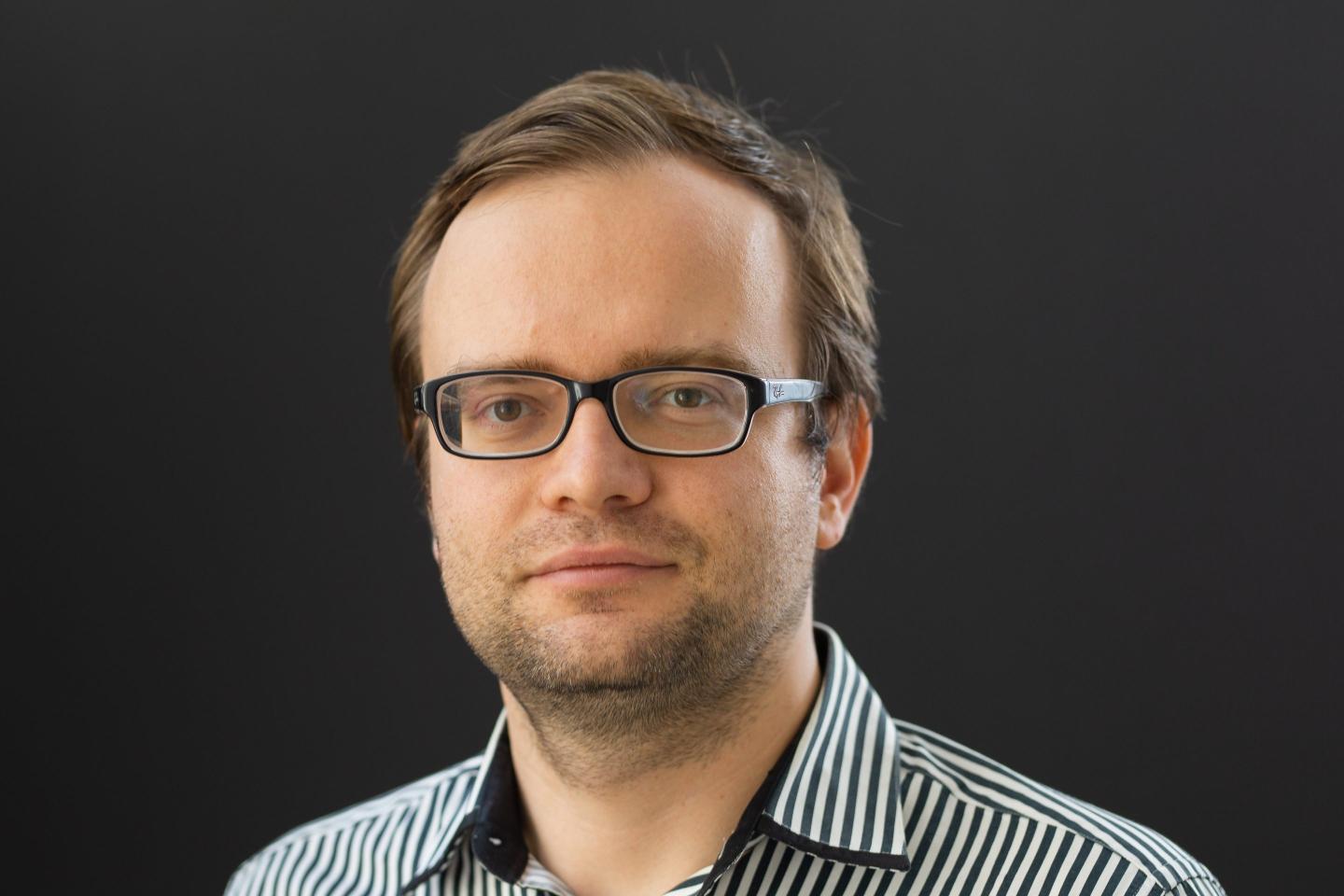 A headshot of Vladimir Novakovski wearing glasses.