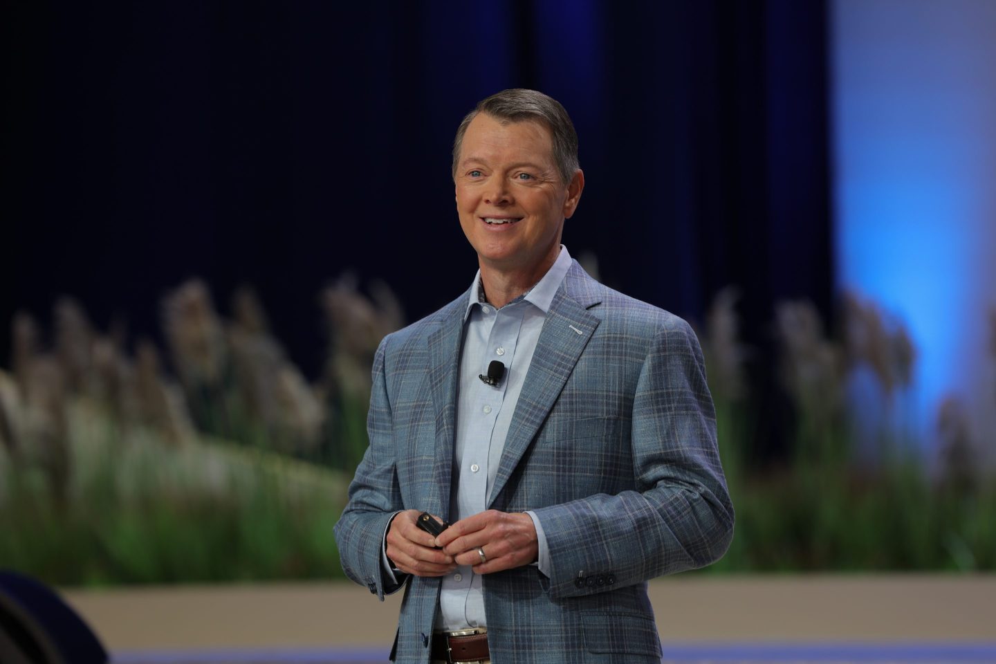 Man wearing a suit and smiling.