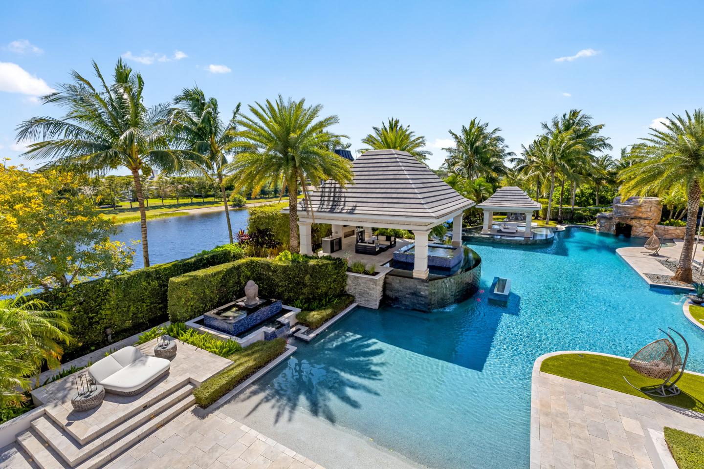 Photo of a huge pool with several seating areas adjacent