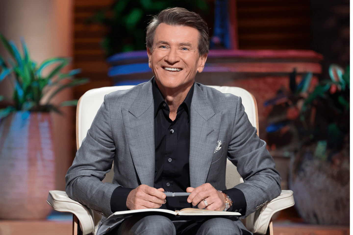 Robert Herjavec sitting on the set of Shark Tank.