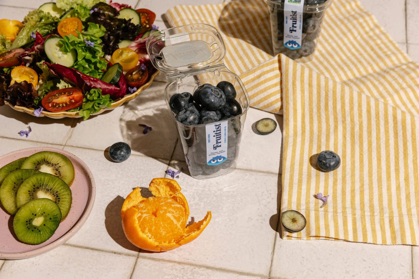 A fruitist snack cup with jumbo-sized blueberries is depicted on a table.