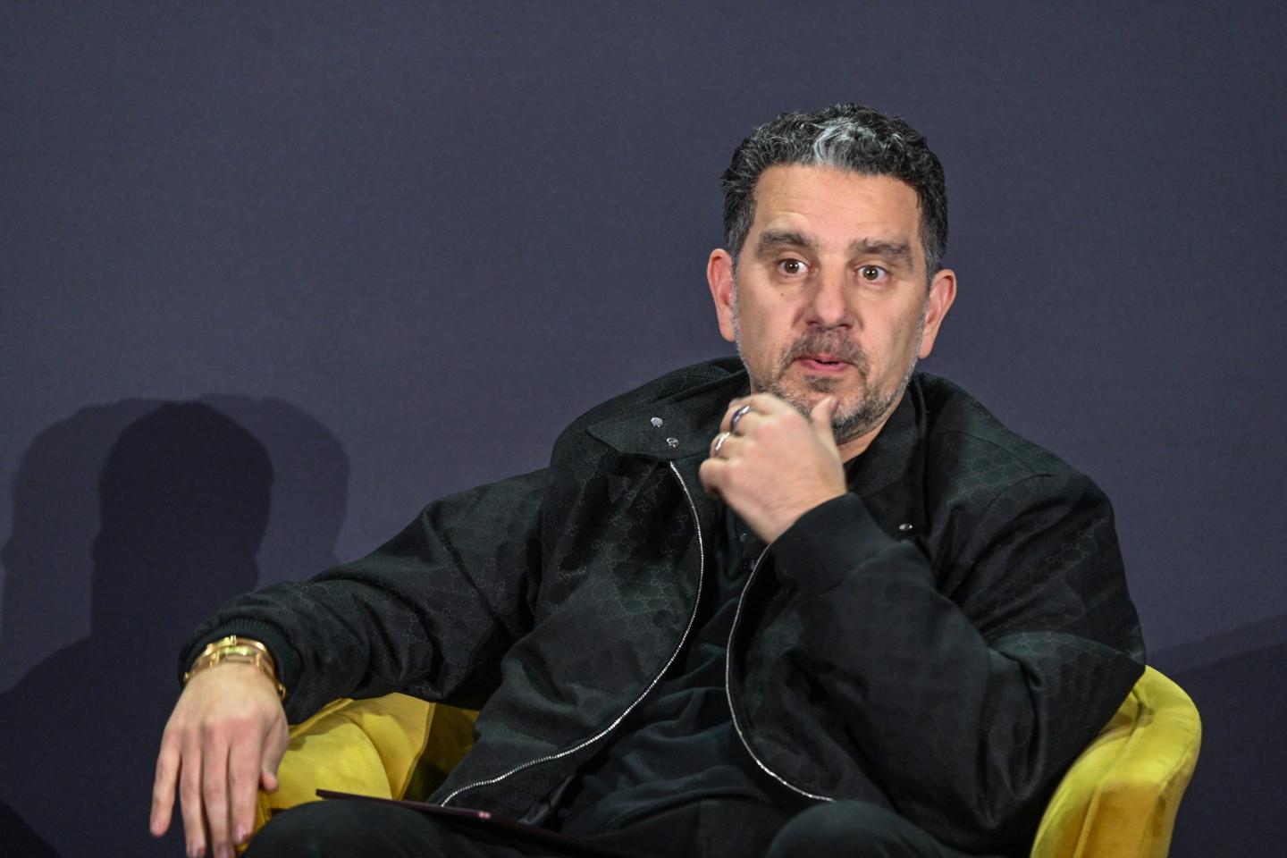 Man in dark jacket sitting on a chair