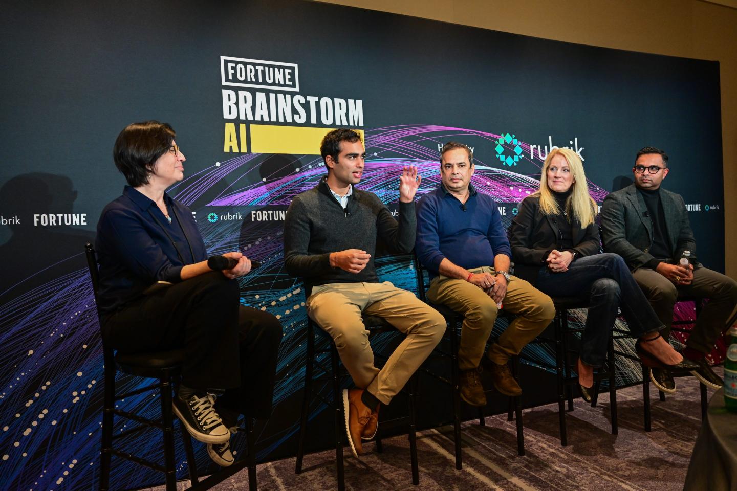 Five panelists seated; two women and five men.