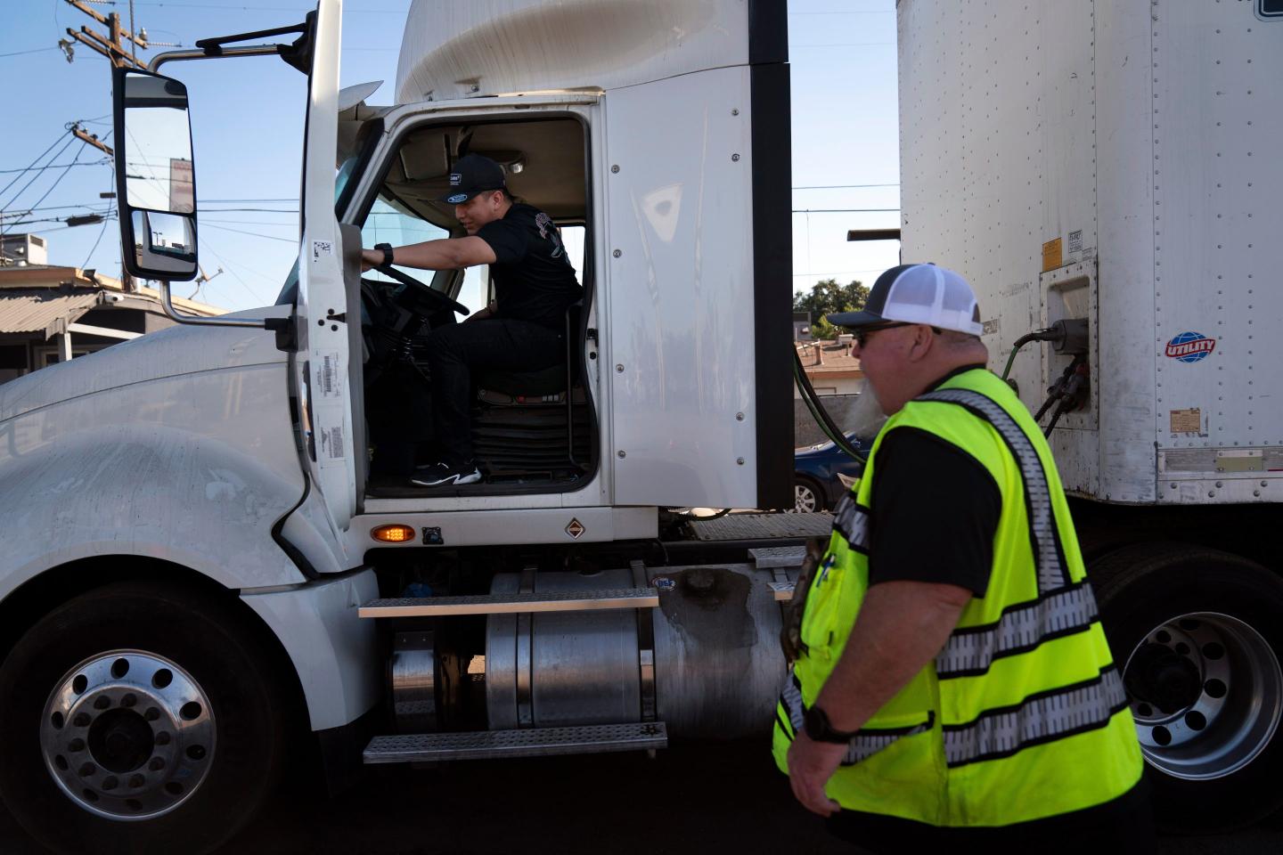 A student driver gets on a truck as the instructor watches in Calif., Nov. 15, 2021.