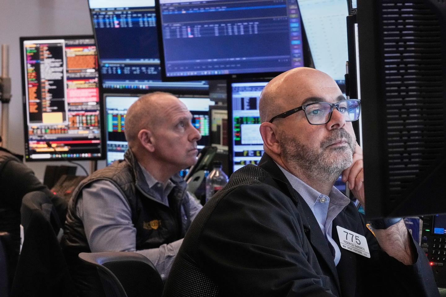 Traders Michael Urkonis, left, and Fred Demarco work on the floor of the New York Stock Exchange, Tuesday, Dec. 2, 2025.