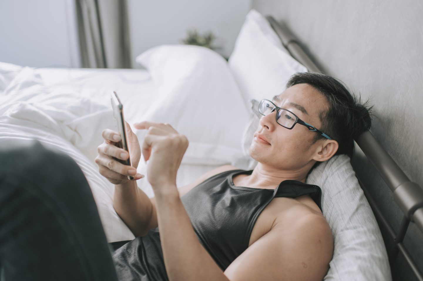 Person checking their phone in bed