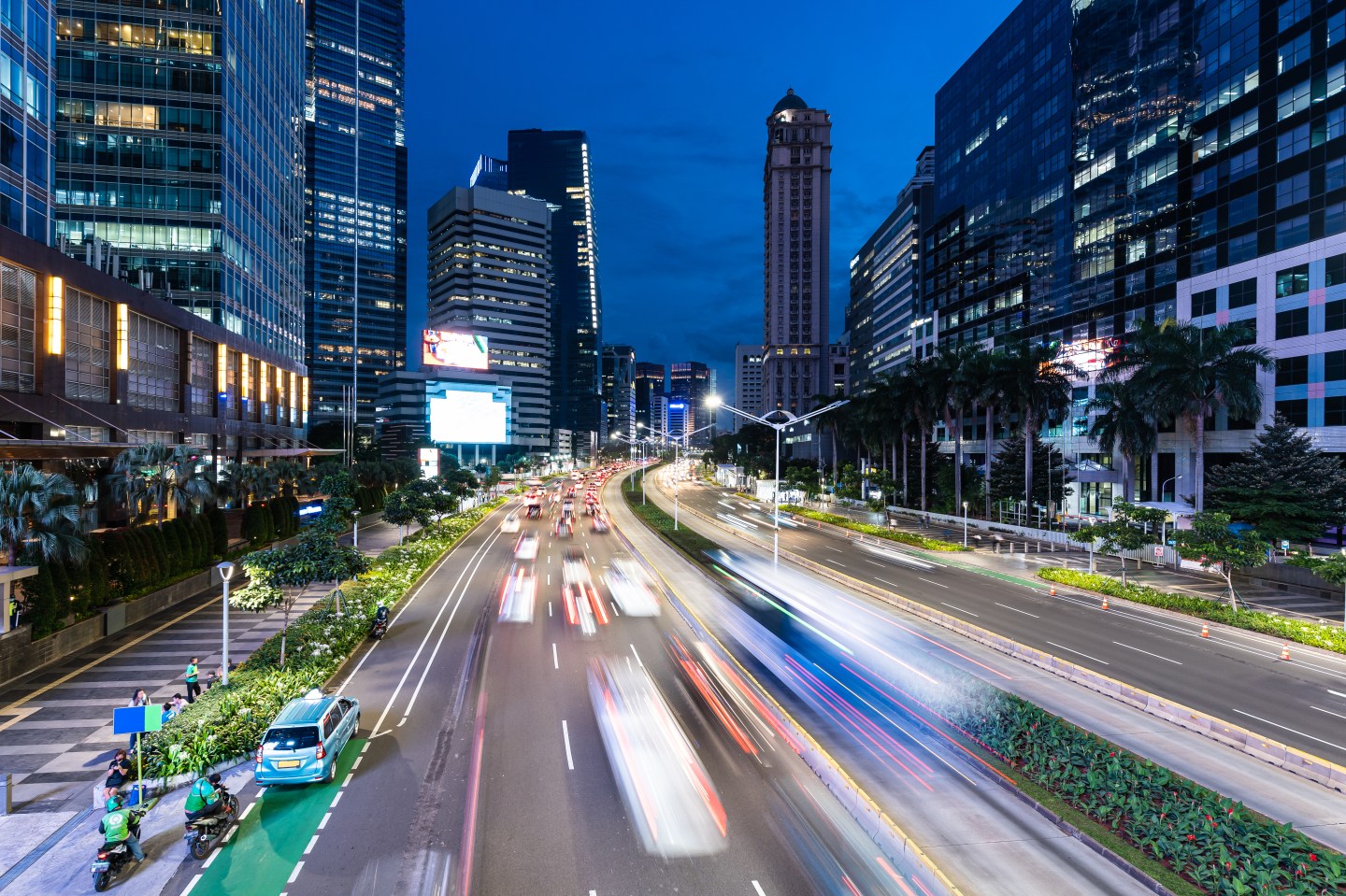 Jakarta, Indonesia: Traffic captured with blurred motion rushing along the Sudirman avenue in the heart of Jakarta business and financial district in Indonesia capital city.