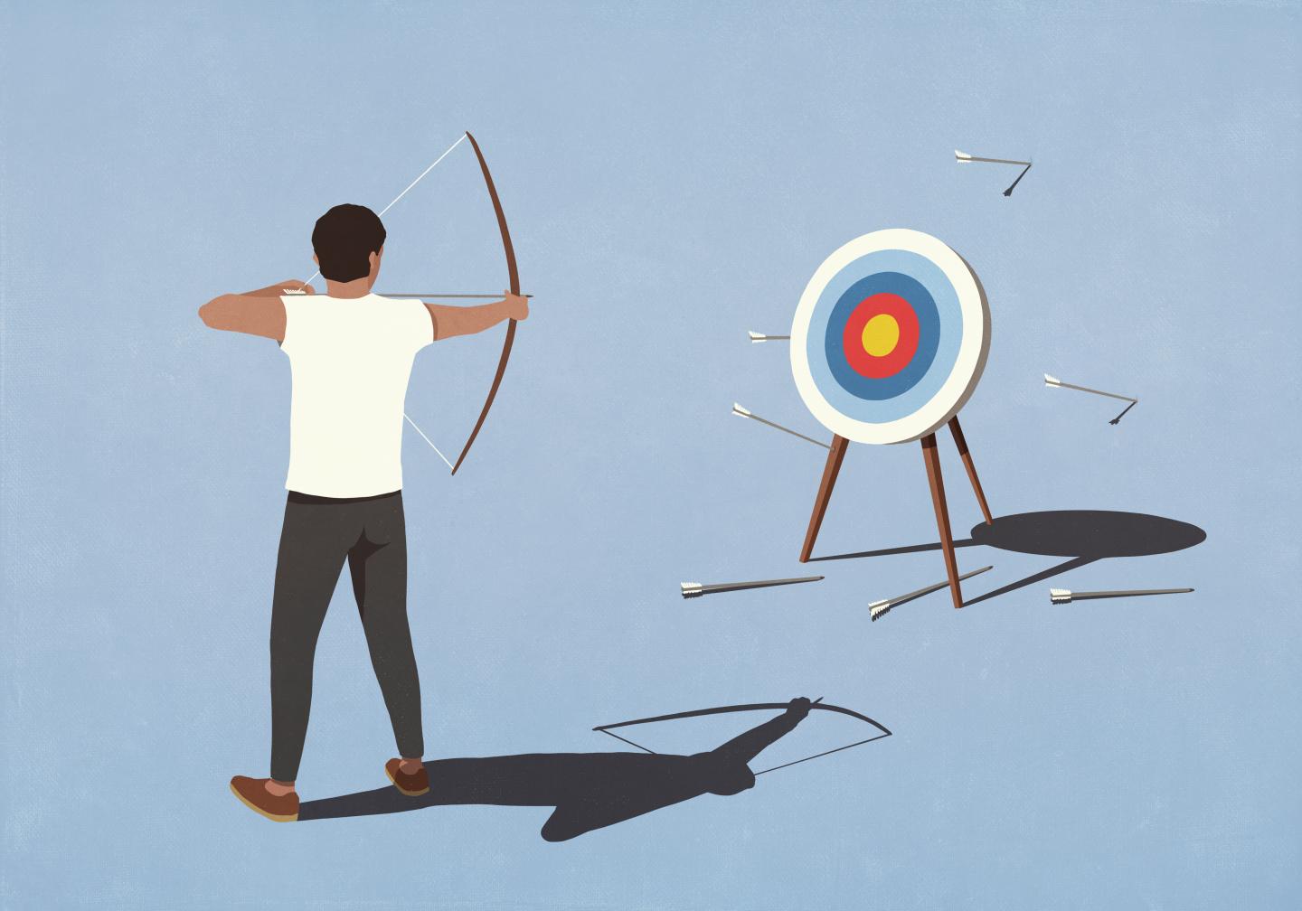 man shooting at target bullseye and missing