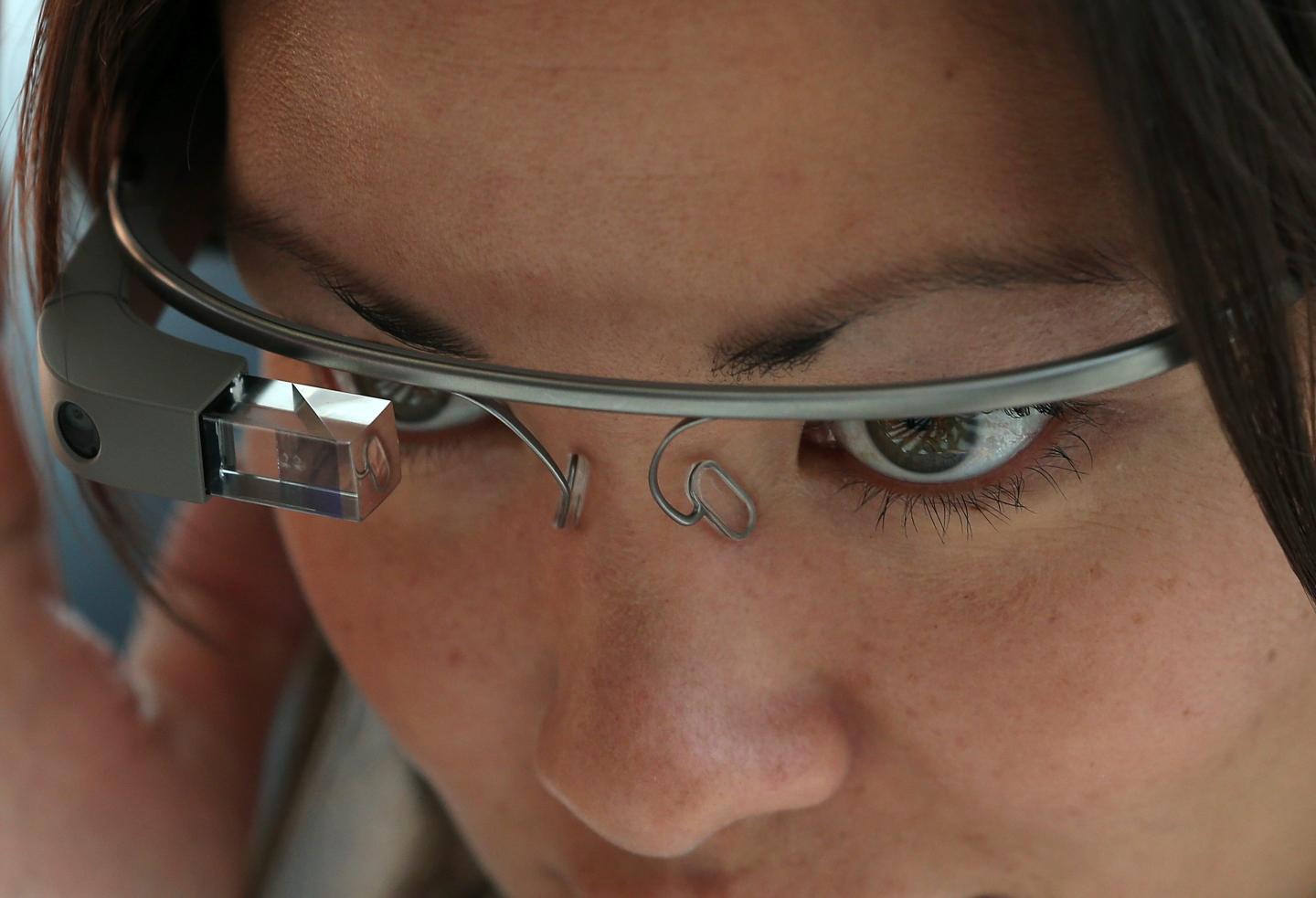 A close-up of a woman using Google Glass