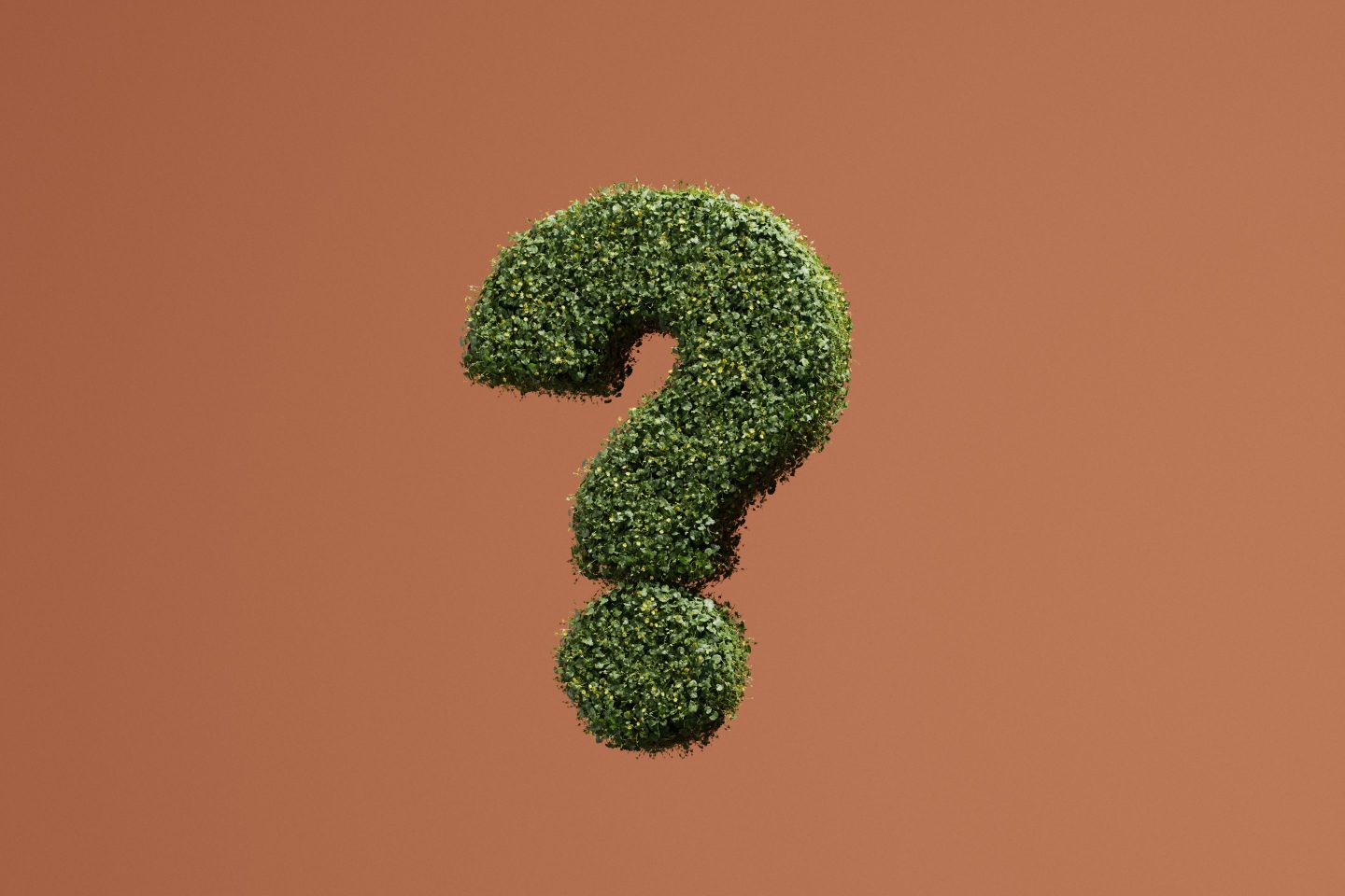 Conceptual image of a levitating question mark fully overgrown with green plants against brown background