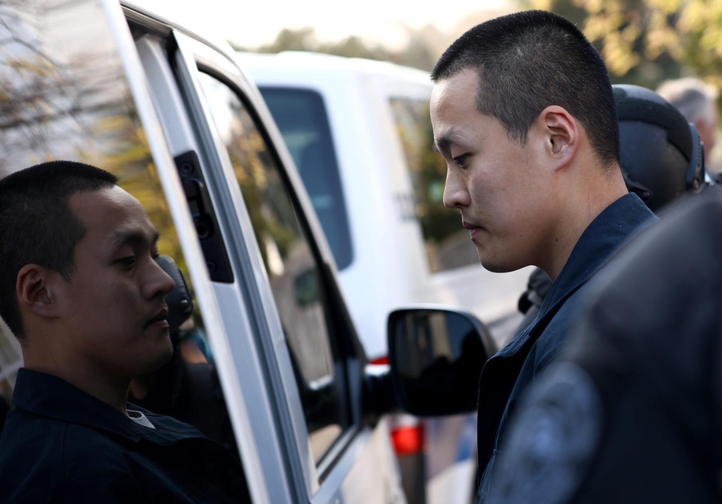 Man about to go into police vehicle