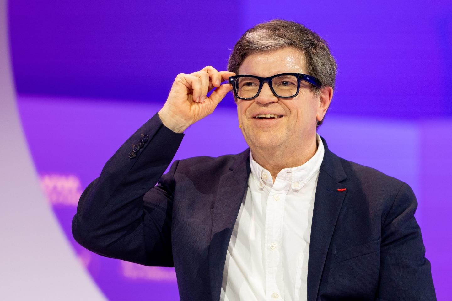 Yann LeCun smiles and adjusts his glasses