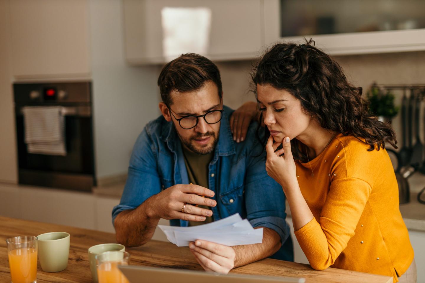A man and a woman look at paperwork together