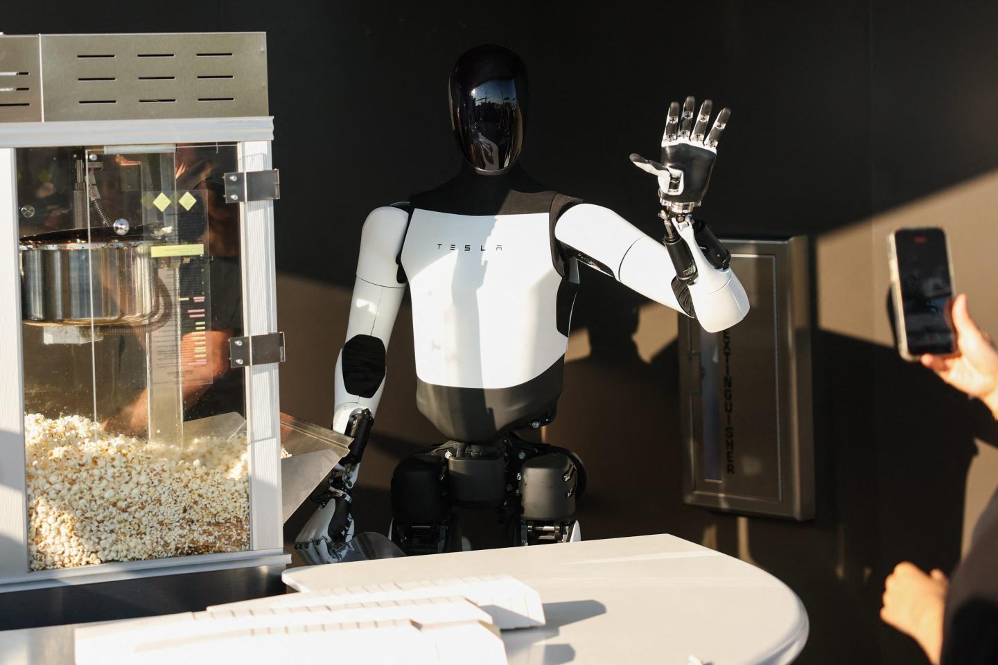An Optimus robot serving in a restaurant