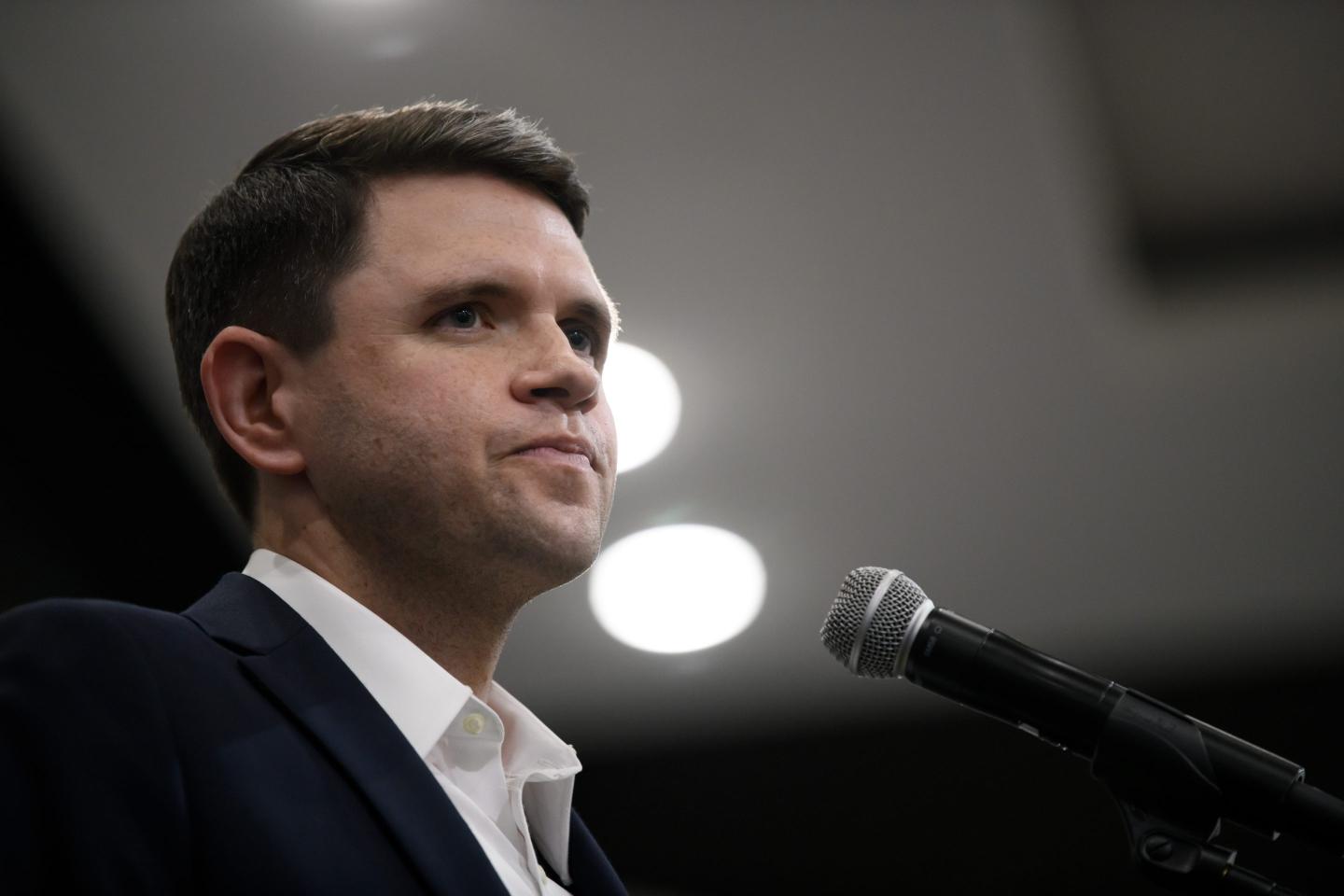 James Talarico stands behind a microphone and stares out into the crowd