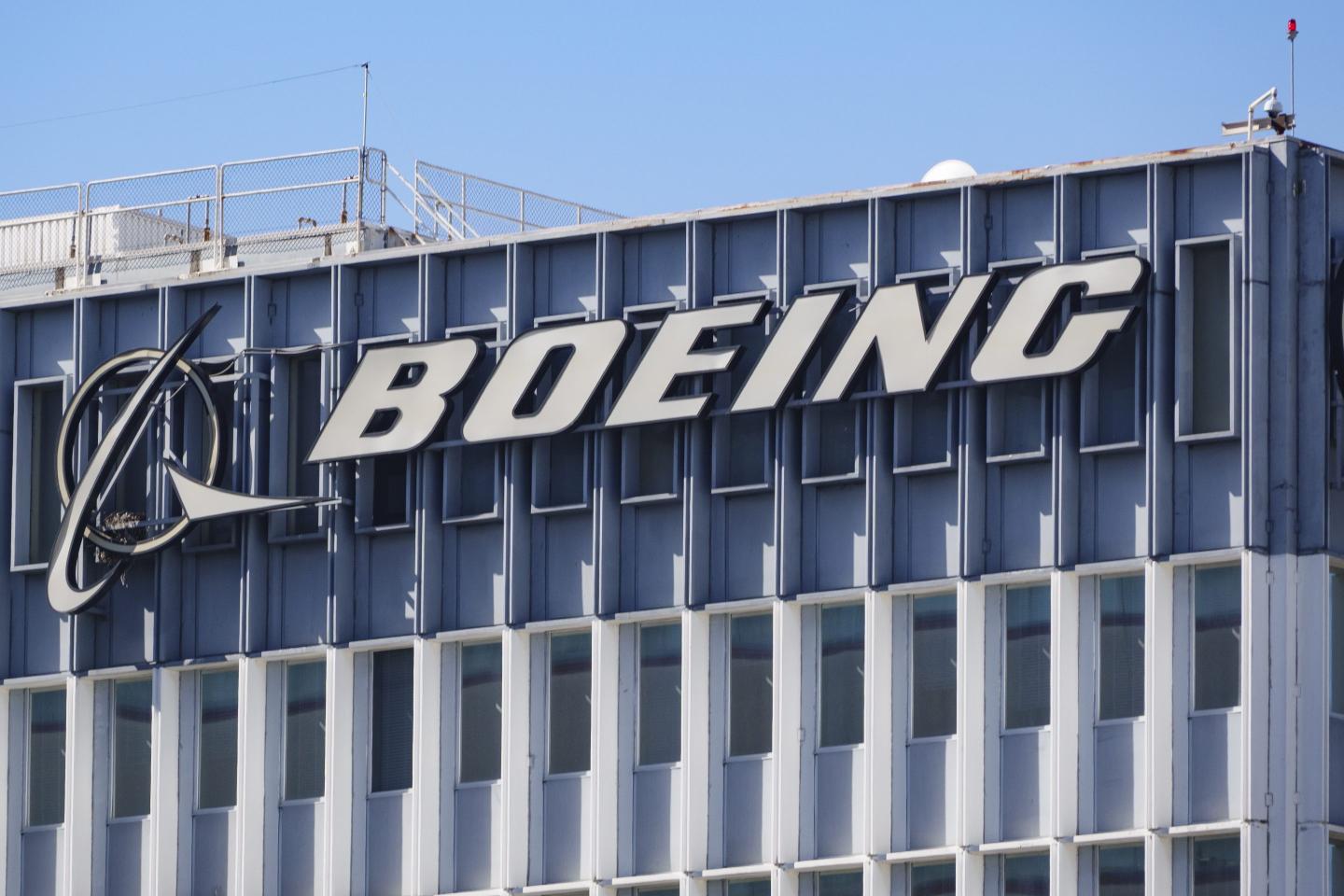 The Boeing logo is displayed on a sign at their building.