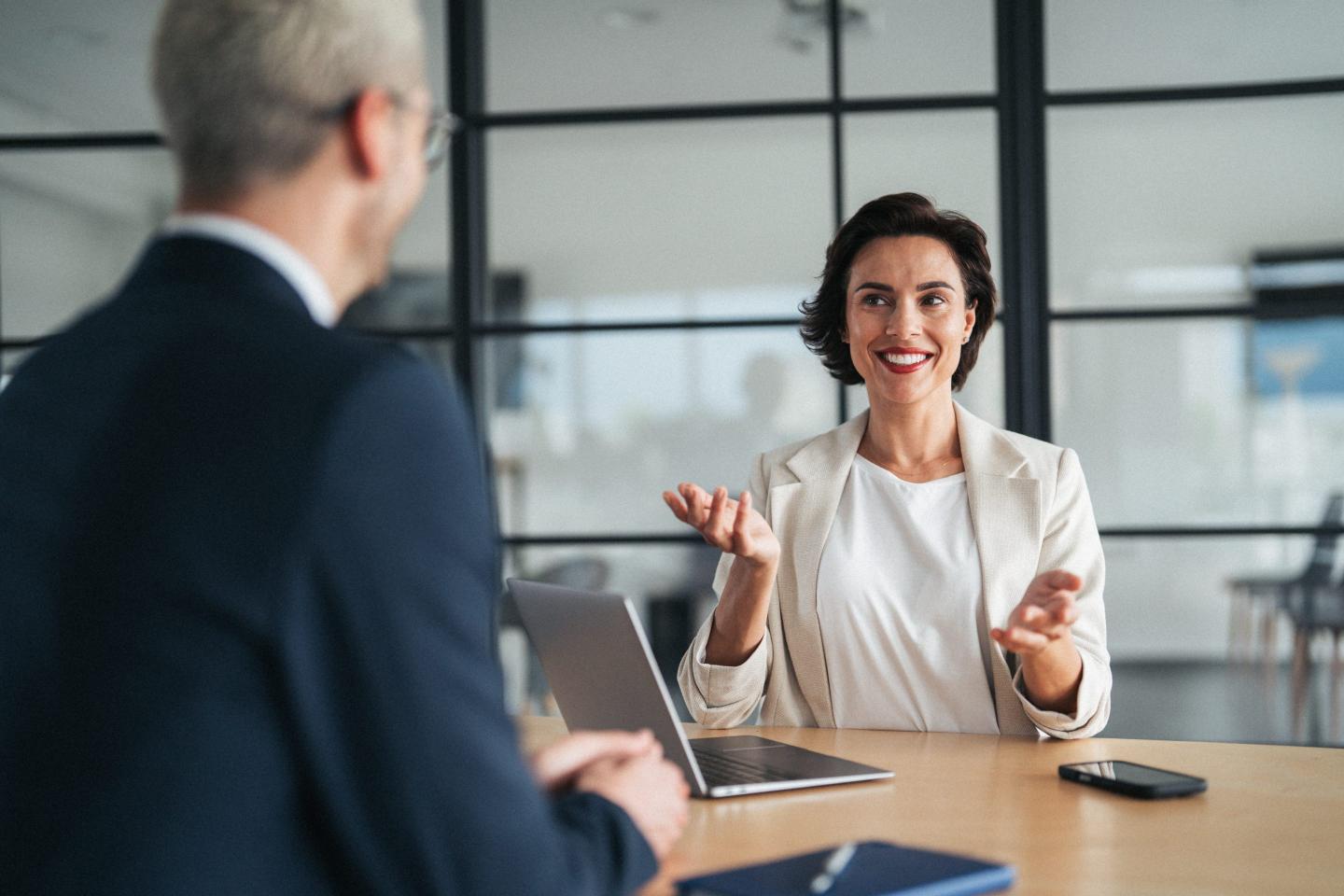 Person at a desk being interviewed for a job