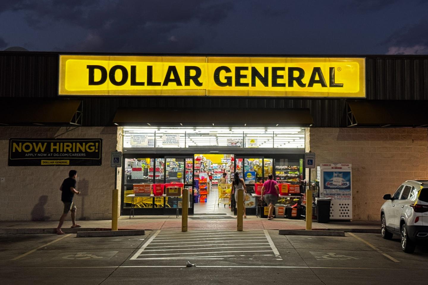 The outside of a Dollar General store, at night