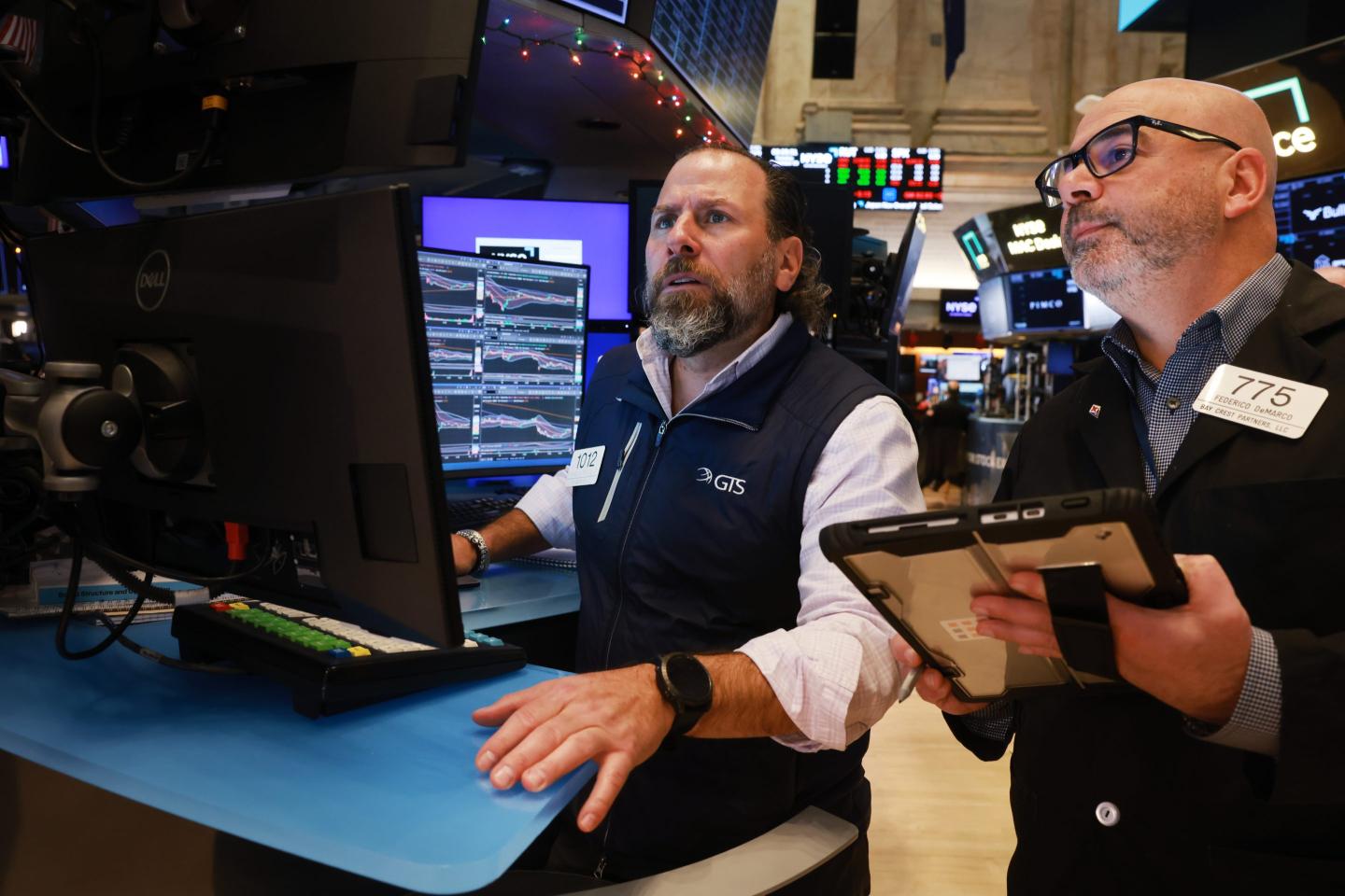 Traders work on the floor of the New York Stock Exchange (NYSE) on December 30, 2025 in New York City.