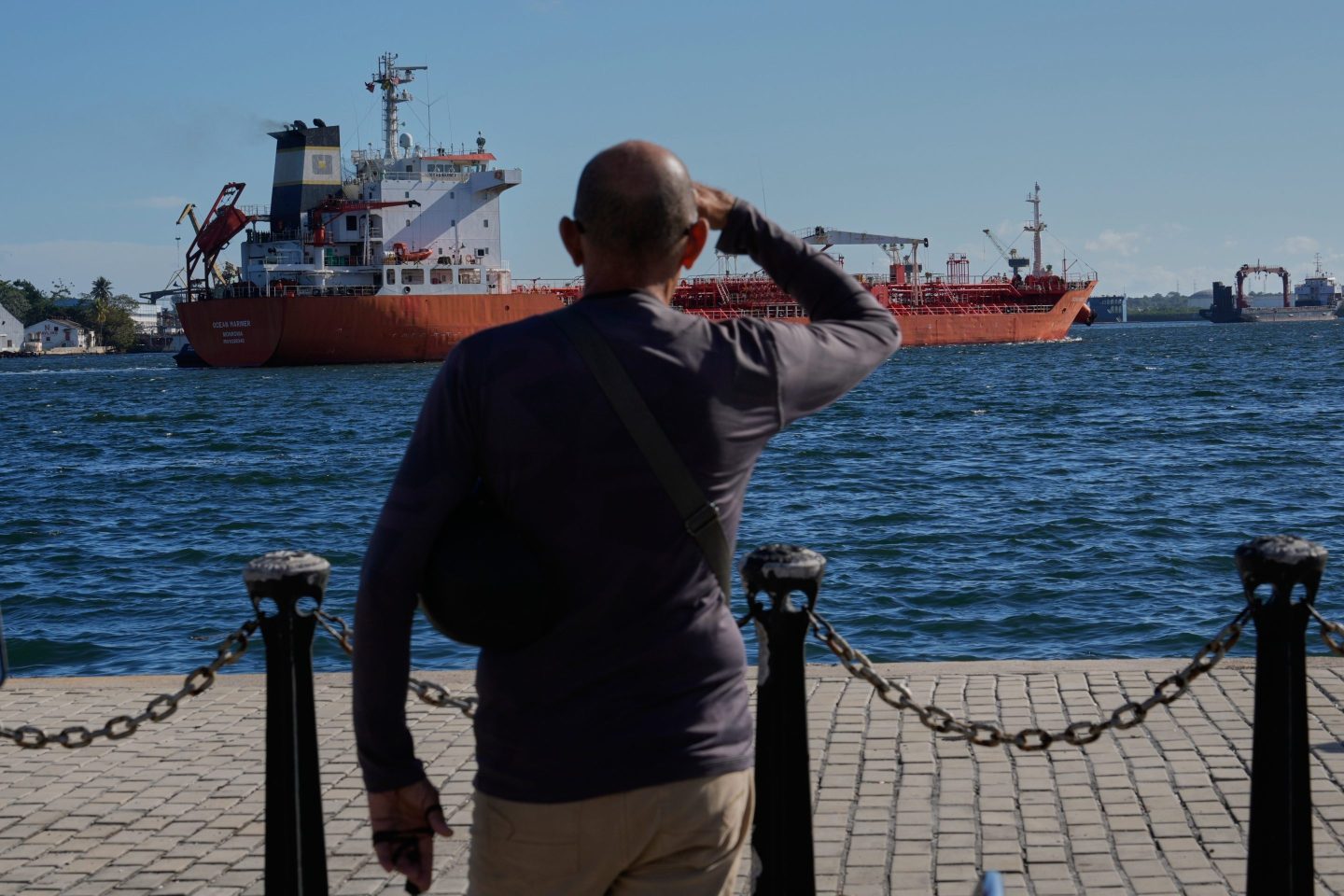 A person watches the oil tanker Ocean Mariner, Monrovia, arrive to the bay in Havana, Cuba, Friday, Jan. 9, 2026. (AP Photo/Ramon Espinosa)