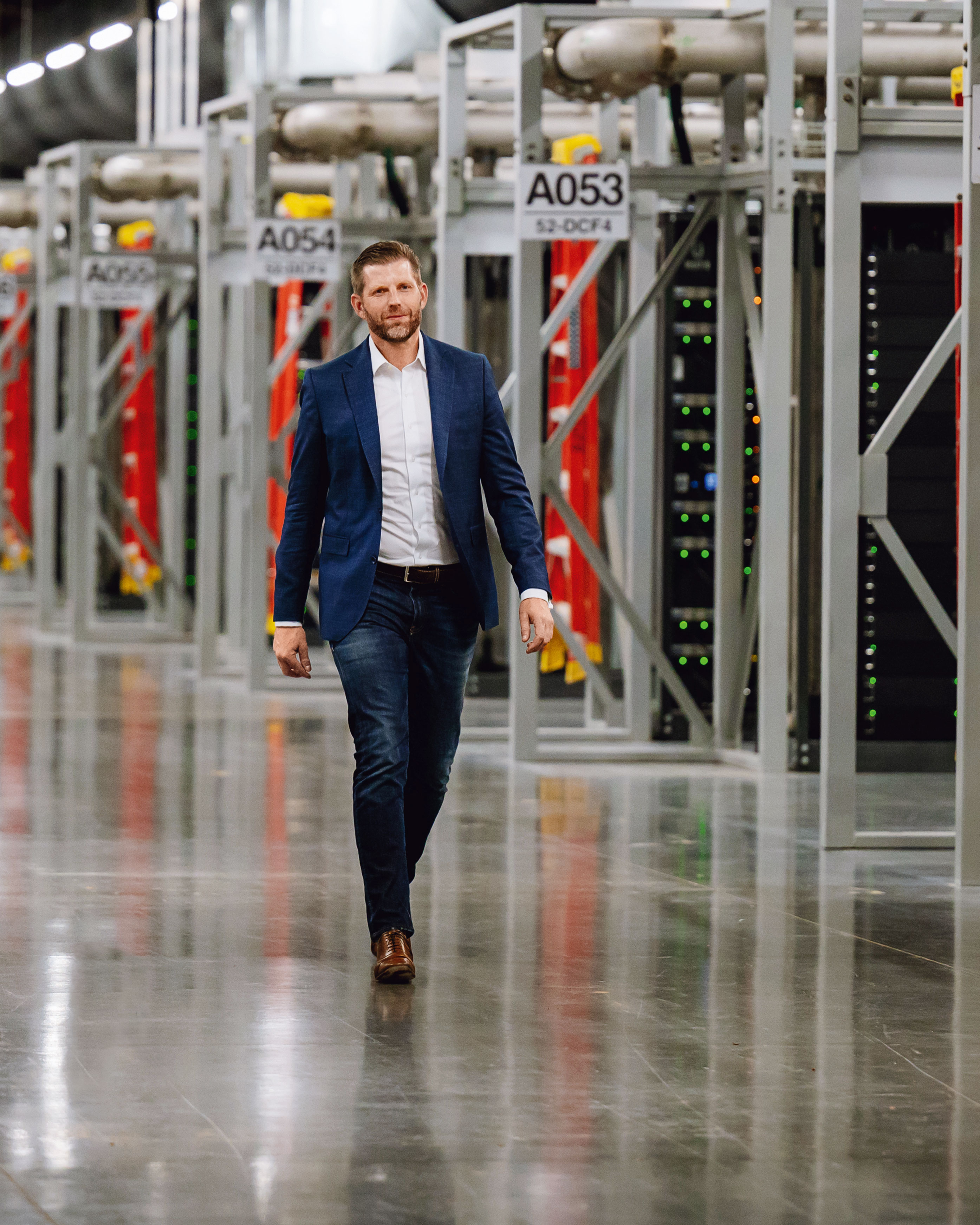 Eric Trump strolls among the mining rigs at American Bitcoin’s data center in Vega, Texas.
