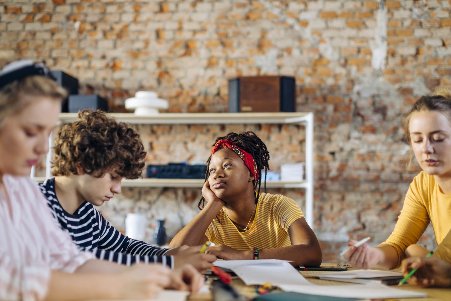Portrait of young woman daydreaming in a meeting