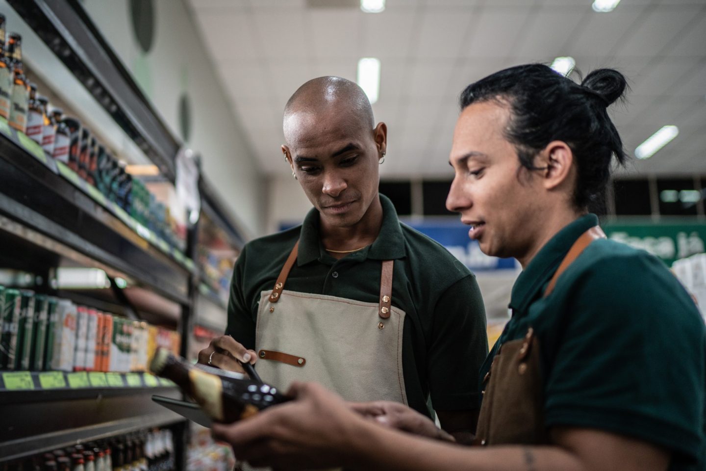 Coworkers working in a supermarket - including a non-binary person