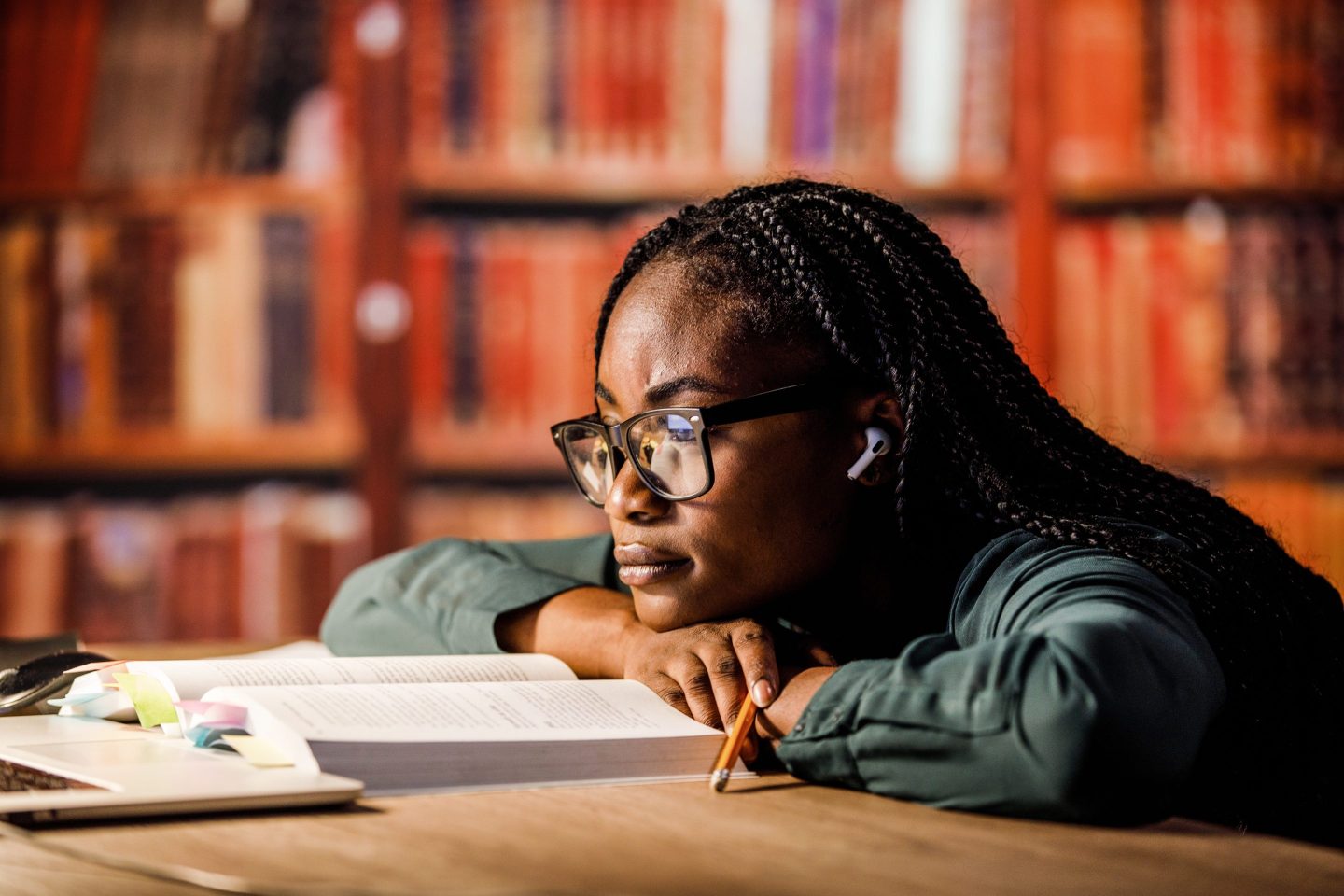 Woman reading a book in a library