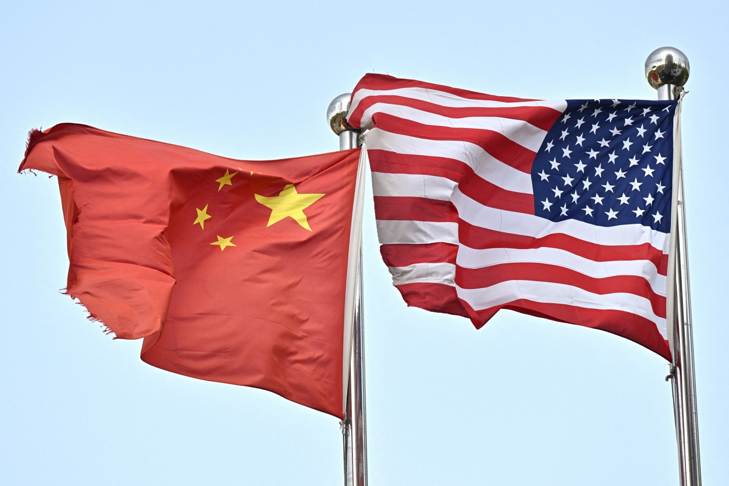 Chinese and U.S. flags wave outside a technology company in Beijing, on April 17, 2025. (Photo: Pedro Pardo/AFP/Getty Images)