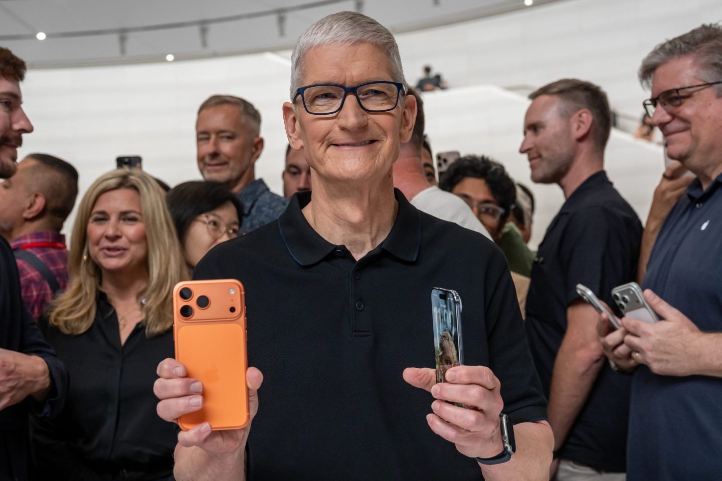 Tim Cook, chief executive officer of Apple Inc., holds the Apple iPhone 17 Pro, left, and iPhone Air during an event at Apple Park campus in Cupertino, California, US, on Tuesday, Sept. 9, 2025. Apple Inc. introduced its iPhone 17 lineup, adding an all-new skinnier Air design and improving the devices' durability and camera technology. Photographer: David Paul Morris/Bloomberg via Getty Images