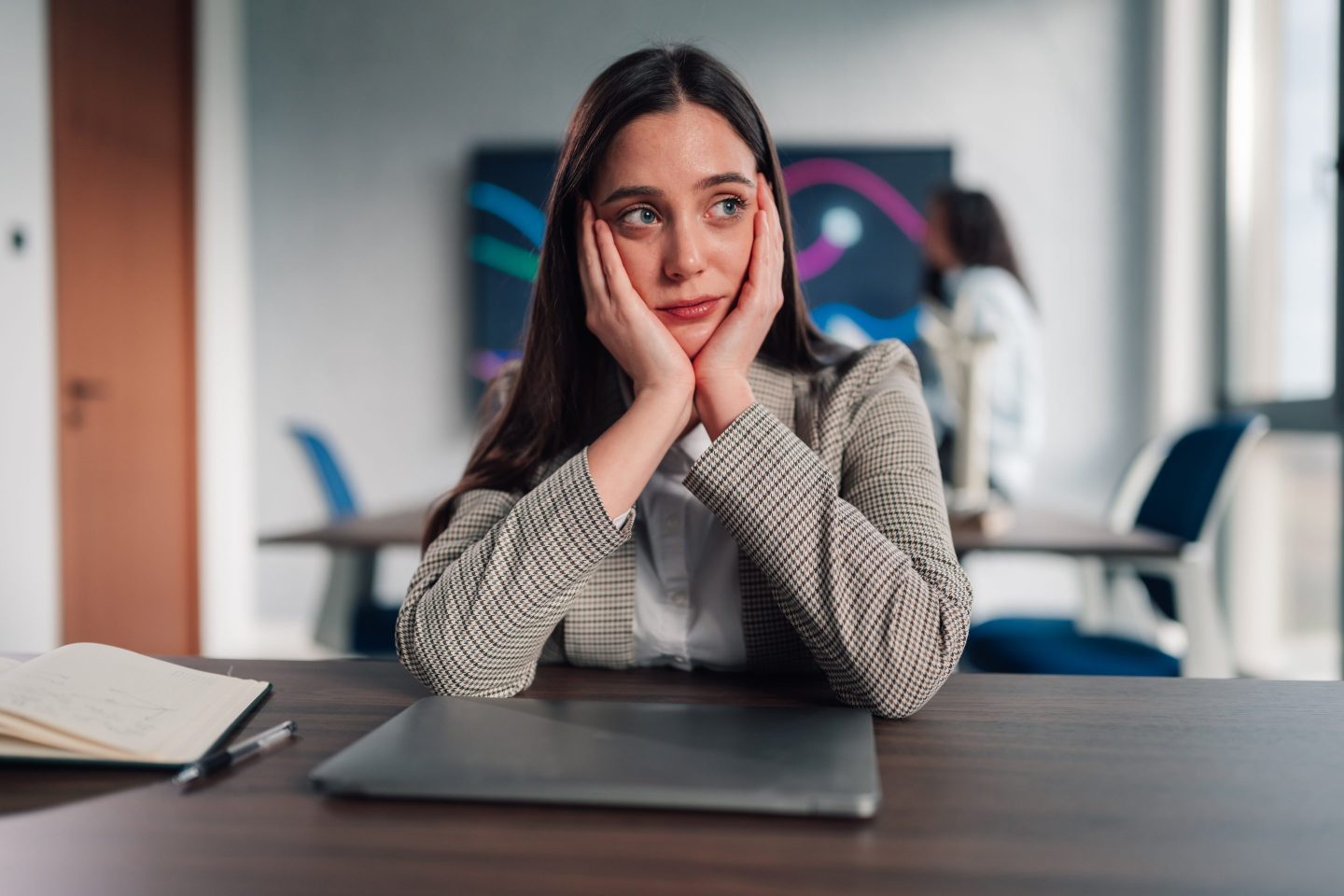 Lonely young woman in office