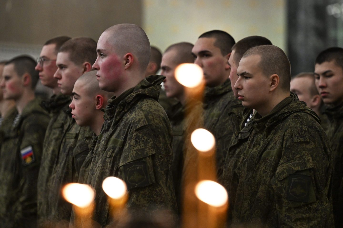 Russian servicemen, involved in the so-called 'special military operation' in Ukraine,  attend a Christmas service at the Kronstadt Naval Cathedral in Saint Petersburg on January 6, 2026. Orthodox Christians celebrate Christmas on January 7 in the Middle East, Russia and other Orthodox churches that use the old Julian calendar instead of the 17th-century Gregorian calendar adopted by Catholics, Protestants, Greek Orthodox and commonly used in secular life around the world. (Photo by Olga MALTSEVA / AFP via Getty Images)