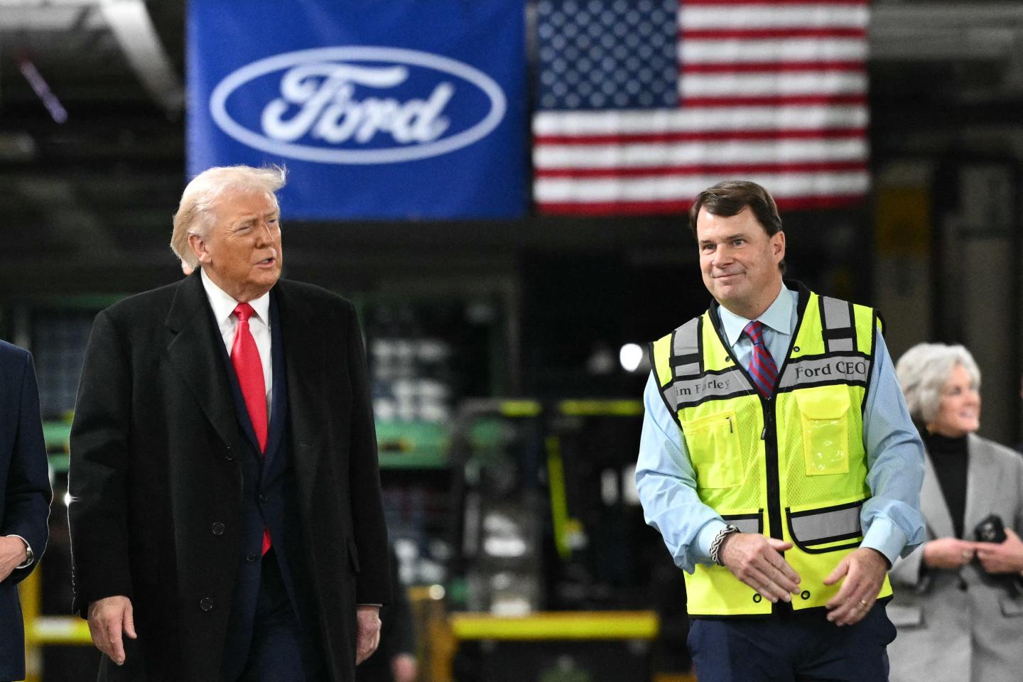 Donald Trump and Jim Farley walk next to each other in the Ford factory.