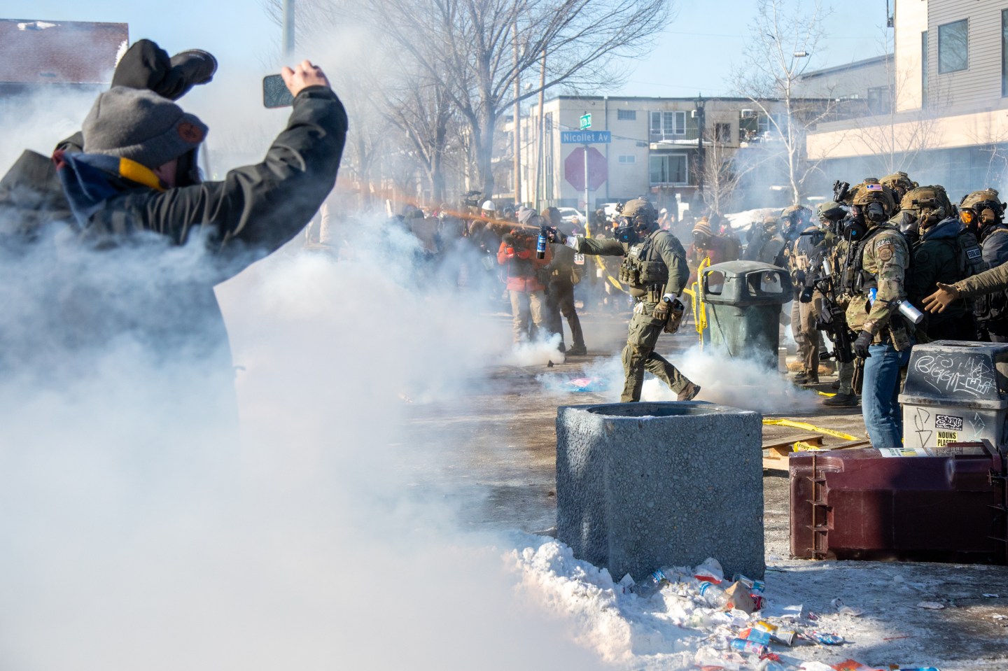Protestors stand and film federal agents.
