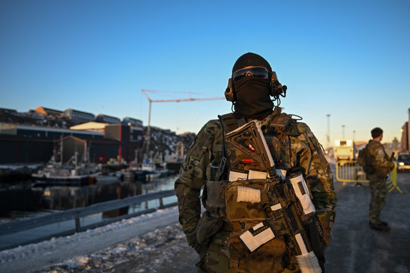 A Danish soldier stands at a checkpoint in the harbor of Nuuk, Greenland's capital.