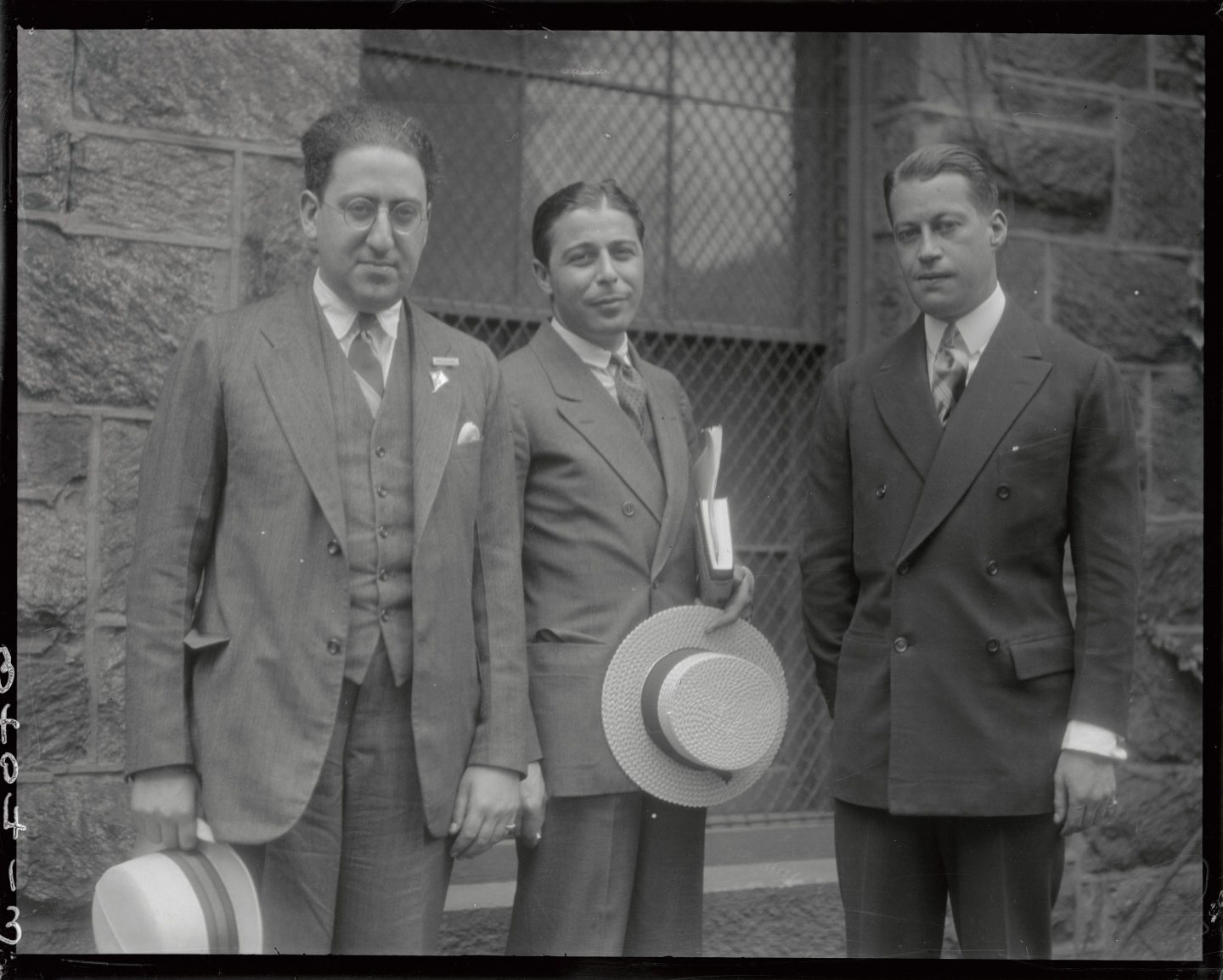 A black and white photo of three men in suits.