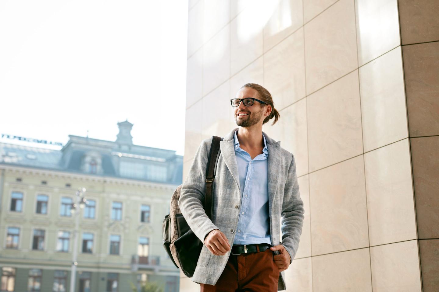Rich young man walking into office