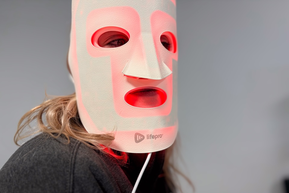 Our tester using the RevitaGlow red light therapy mask.