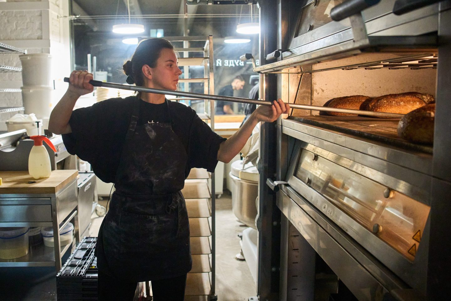 Olha Hrynchuk, 28, owner of a bakery, bakes bread early morning running on a generator during a blackout caused by Russia's regular air attacks on the country's energy system Friday, Jan. 30, 2026 in Kyiv. (AP Photo/Efrem Lukatsky)